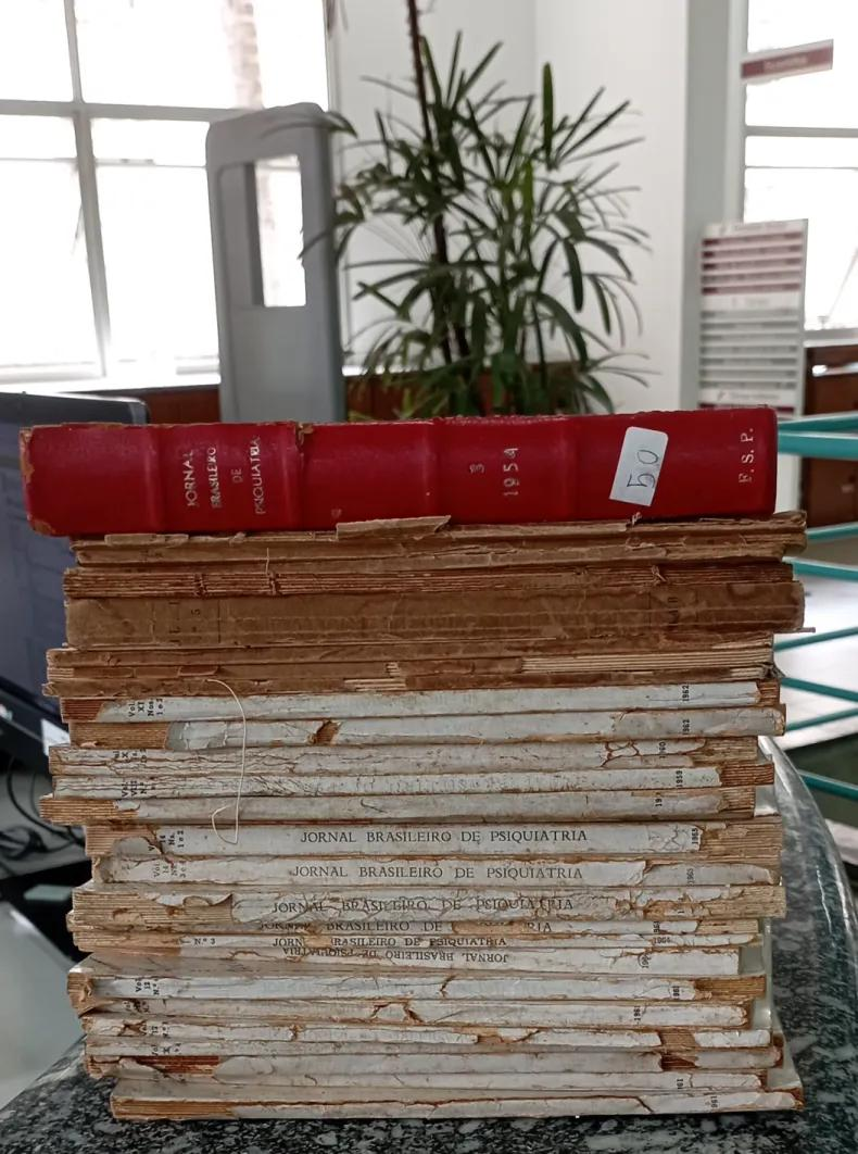 An archive of old books stacked vertically