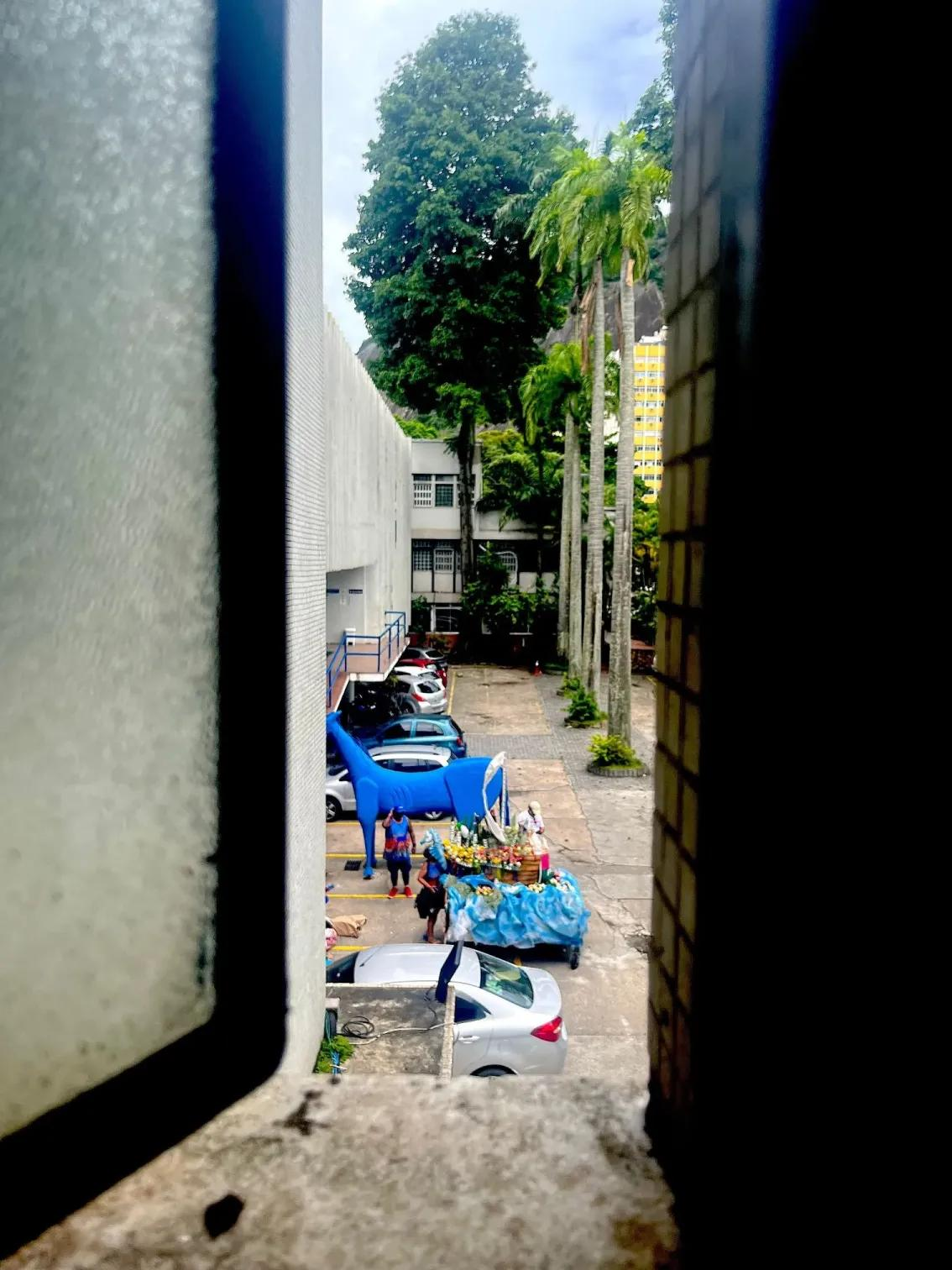 A collection of carnival items, including a blue model horse, in a car park