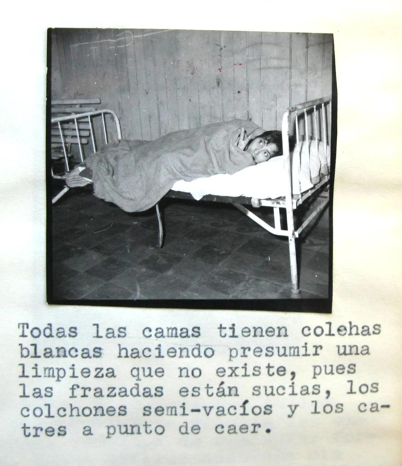 A single metal-framed bed and patient in a psychiatric hospital ward circa 1962
