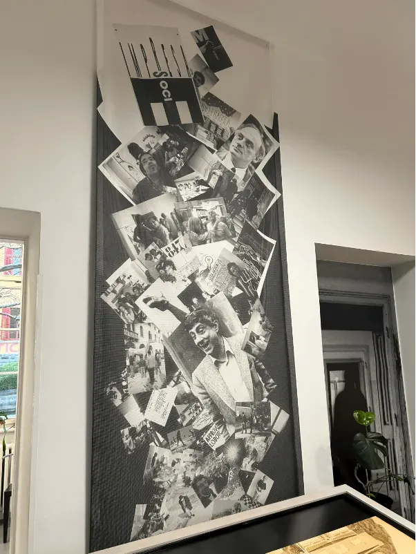 A black and white photo collage hanging on a white wall